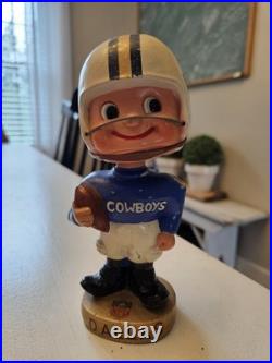 Vintage 1962 Dallas Cowboys bobblehead with gold base, toes up. RARE