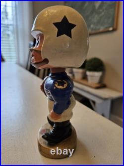 Vintage 1962 Dallas Cowboys bobblehead with gold base, toes up. RARE