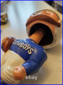 Vintage 1962 Dallas Cowboys bobblehead with gold base, toes up. RARE