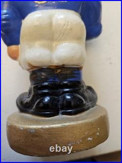 Vintage 1962 Dallas Cowboys bobblehead with gold base, toes up. RARE