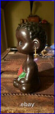 Vintage bobblehead african child bank with watermelon, missing stopper on bottom